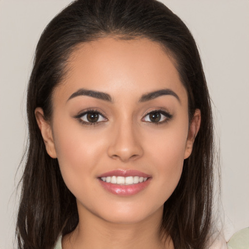 Joyful white young-adult female with long  brown hair and brown eyes