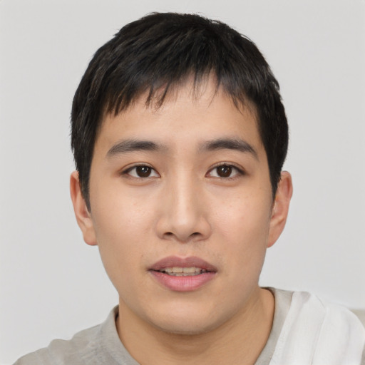 Joyful asian young-adult male with short  black hair and brown eyes