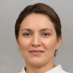 Joyful white adult female with medium  brown hair and brown eyes