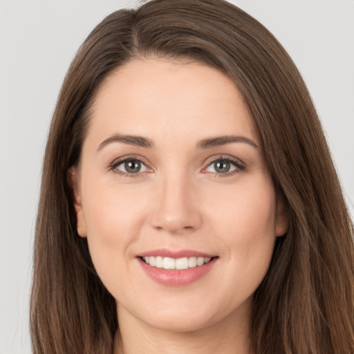 Joyful white young-adult female with long  brown hair and brown eyes