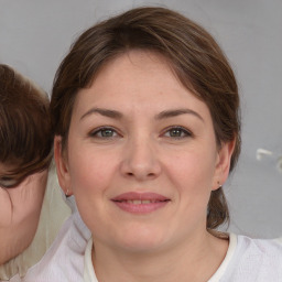 Joyful white young-adult female with medium  brown hair and brown eyes