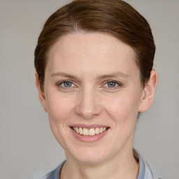 Joyful white young-adult female with short  brown hair and grey eyes