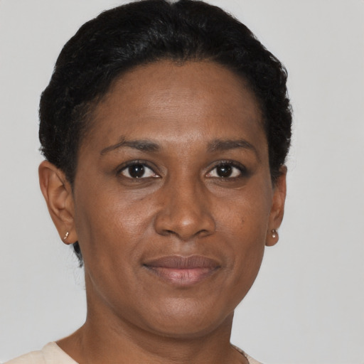 Joyful black adult female with short  black hair and brown eyes