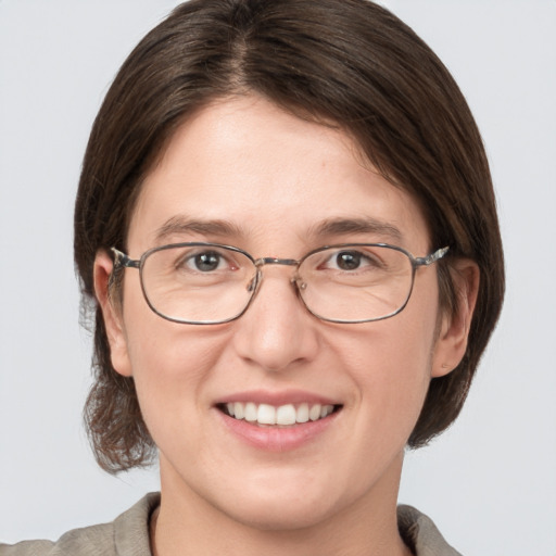 Joyful white adult female with medium  brown hair and grey eyes