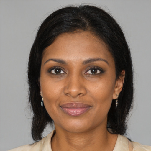 Joyful black young-adult female with medium  brown hair and brown eyes