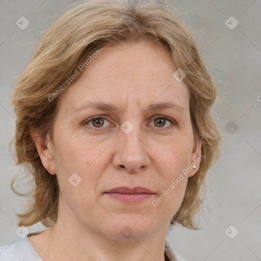 Joyful white adult female with medium  brown hair and blue eyes