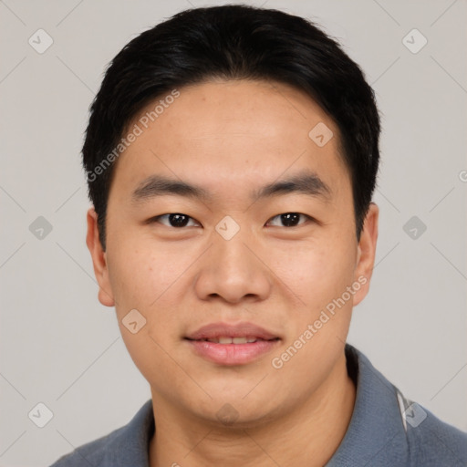 Joyful asian young-adult male with short  black hair and brown eyes