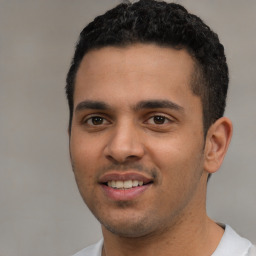 Joyful white young-adult male with short  black hair and brown eyes