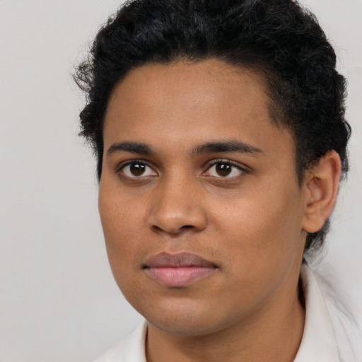 Joyful latino young-adult male with short  brown hair and brown eyes