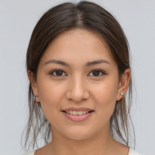 Joyful white young-adult female with long  brown hair and brown eyes
