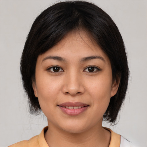 Joyful white young-adult female with medium  brown hair and brown eyes