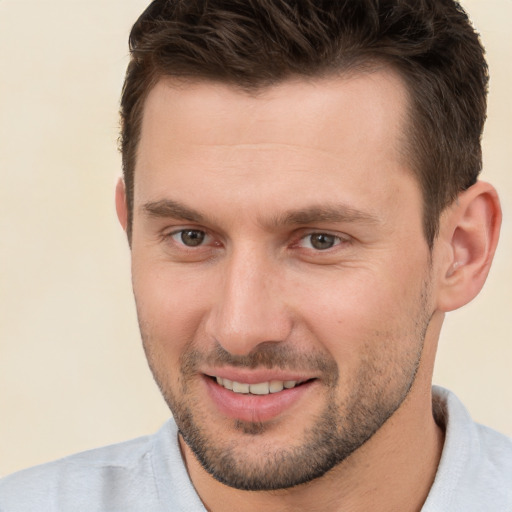 Joyful white young-adult male with short  brown hair and brown eyes