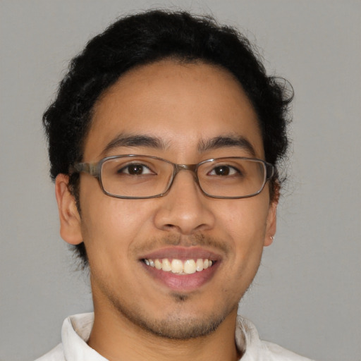 Joyful latino young-adult male with short  brown hair and brown eyes