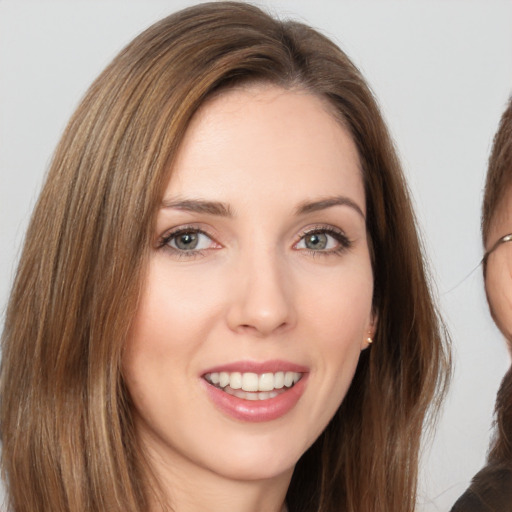 Joyful white young-adult female with long  brown hair and brown eyes