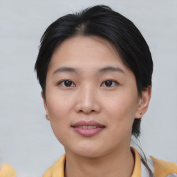 Joyful asian young-adult female with short  brown hair and brown eyes