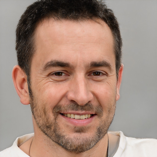 Joyful white adult male with short  brown hair and brown eyes