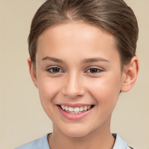 Joyful white child female with short  brown hair and brown eyes