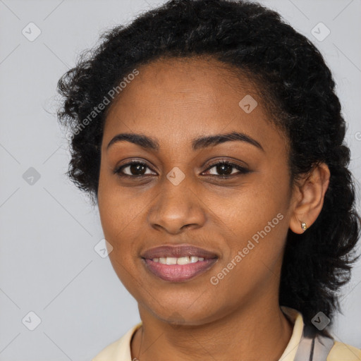 Joyful black young-adult female with long  black hair and brown eyes