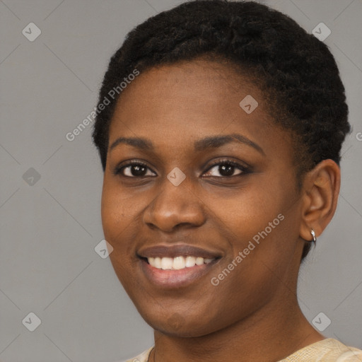 Joyful black young-adult female with short  black hair and brown eyes