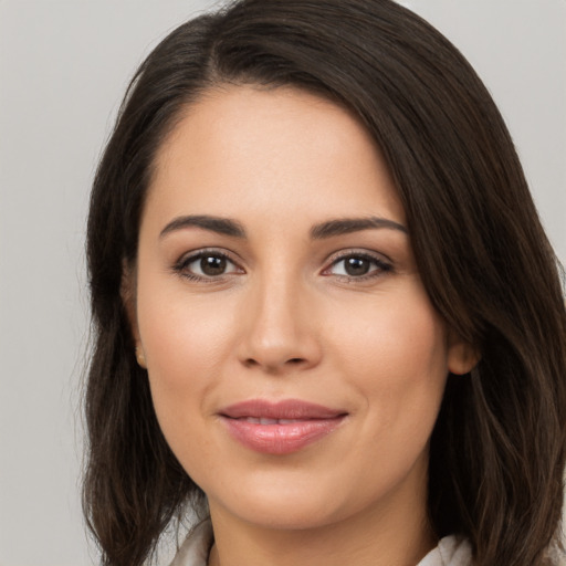 Joyful white young-adult female with long  brown hair and brown eyes