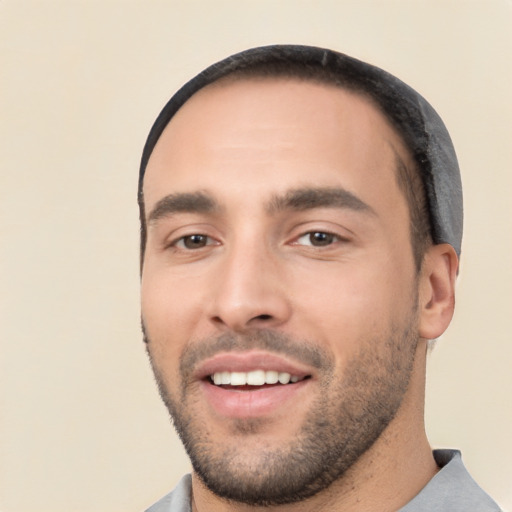 Joyful white young-adult male with short  black hair and brown eyes