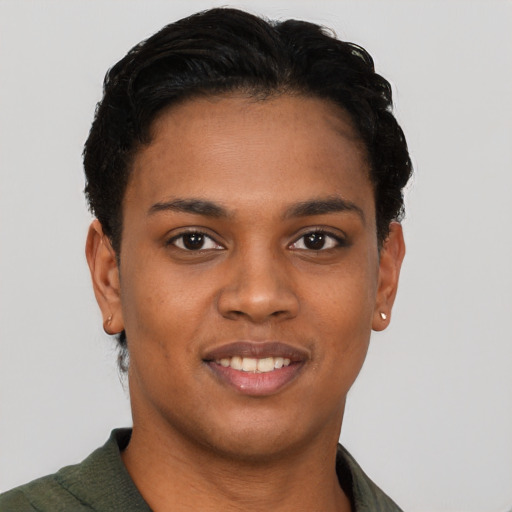 Joyful black young-adult female with short  black hair and brown eyes
