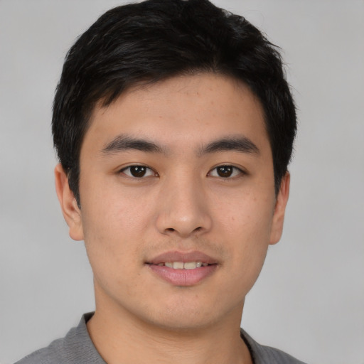 Joyful asian young-adult male with short  black hair and brown eyes