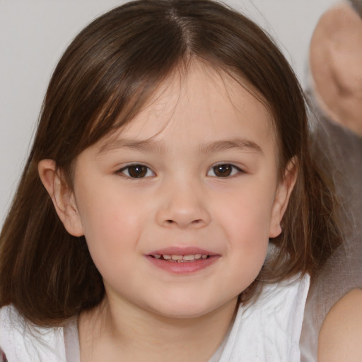 Joyful white child female with medium  brown hair and brown eyes