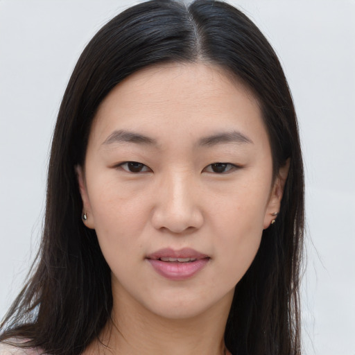 Joyful asian young-adult female with long  brown hair and brown eyes