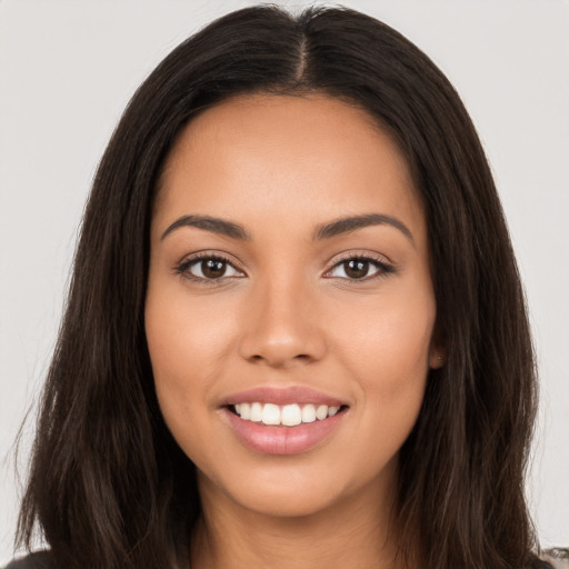 Joyful white young-adult female with long  brown hair and brown eyes