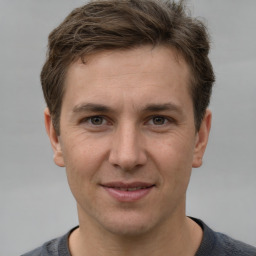 Joyful white adult male with short  brown hair and grey eyes