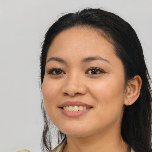 Joyful asian young-adult female with long  black hair and brown eyes
