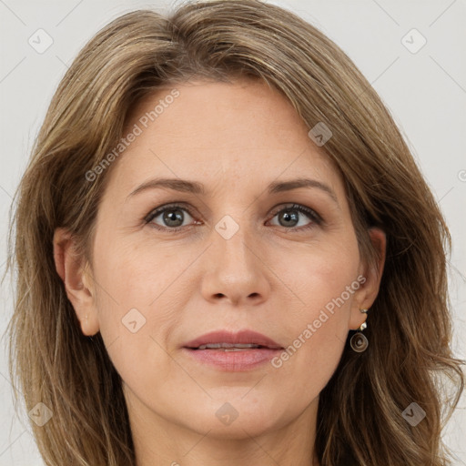 Joyful white adult female with long  brown hair and grey eyes