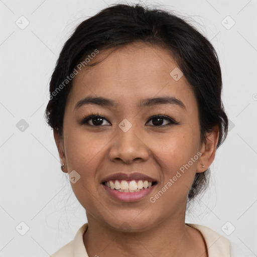 Joyful latino young-adult female with medium  brown hair and brown eyes