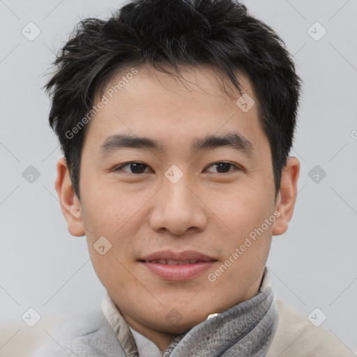 Joyful asian young-adult male with short  black hair and brown eyes