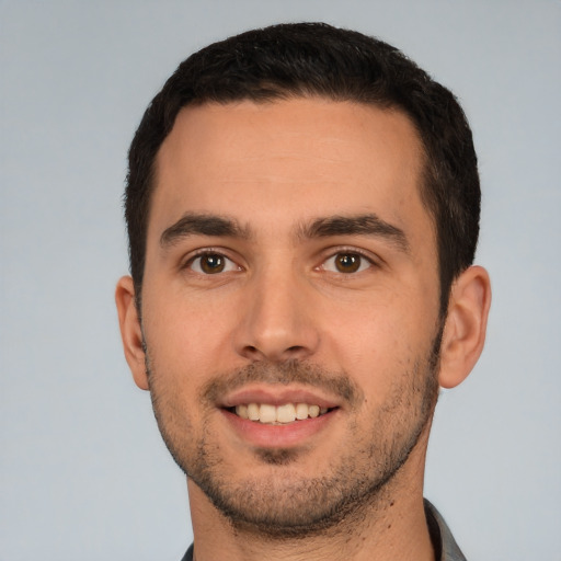 Joyful white young-adult male with short  brown hair and brown eyes