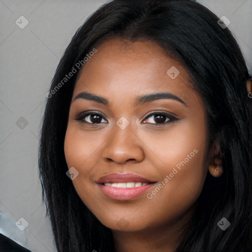 Joyful black young-adult female with long  black hair and brown eyes