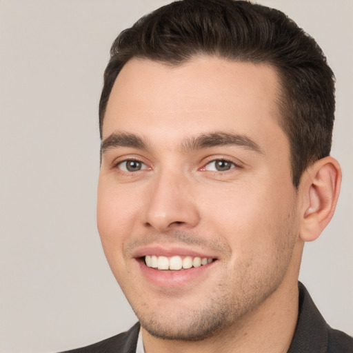 Joyful white young-adult male with short  brown hair and brown eyes