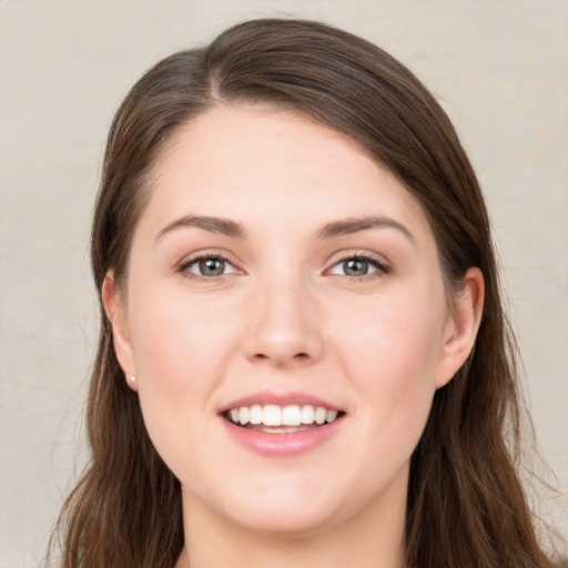 Joyful white young-adult female with long  brown hair and grey eyes