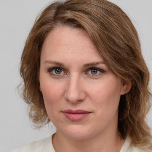 Joyful white young-adult female with medium  brown hair and blue eyes