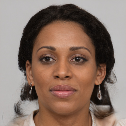 Joyful black young-adult female with medium  brown hair and brown eyes