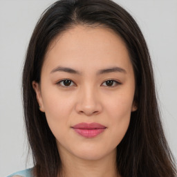 Joyful asian young-adult female with long  brown hair and brown eyes