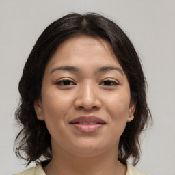 Joyful asian young-adult female with medium  brown hair and brown eyes