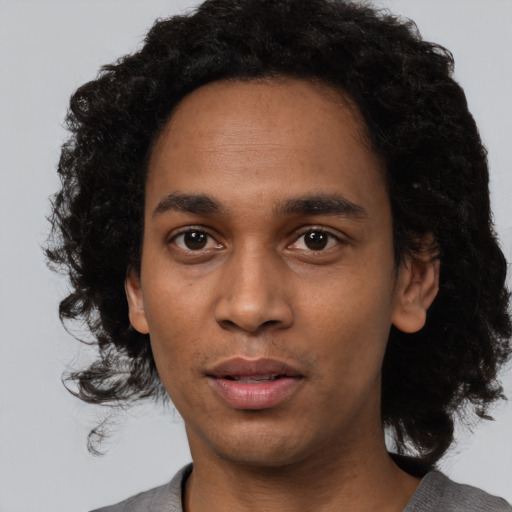 Neutral black young-adult male with medium  black hair and brown eyes