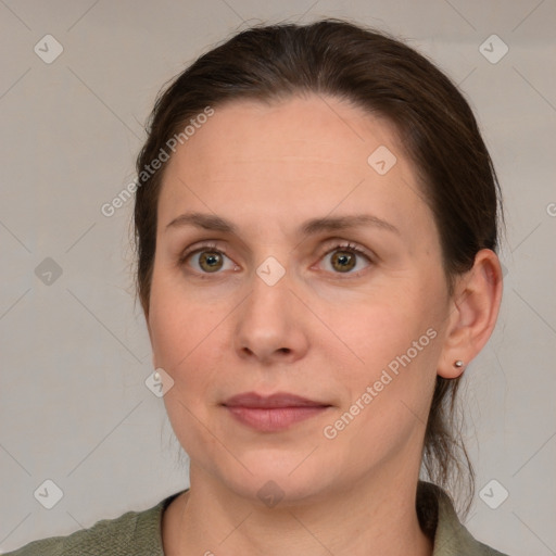 Joyful white adult female with medium  brown hair and grey eyes