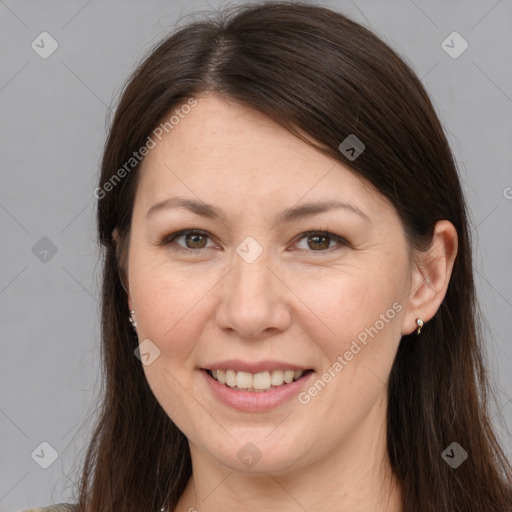 Joyful white adult female with long  brown hair and brown eyes