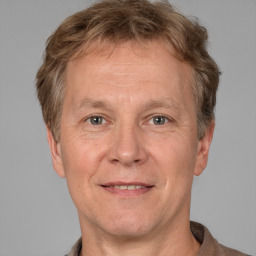 Joyful white adult male with short  brown hair and grey eyes