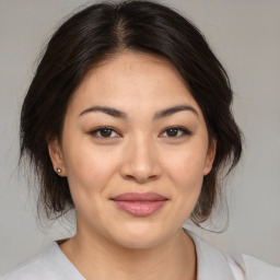 Joyful asian young-adult female with medium  brown hair and brown eyes