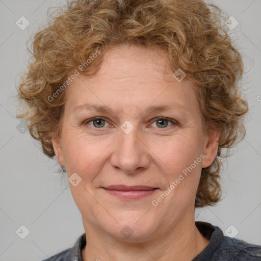 Joyful white adult female with medium  brown hair and blue eyes