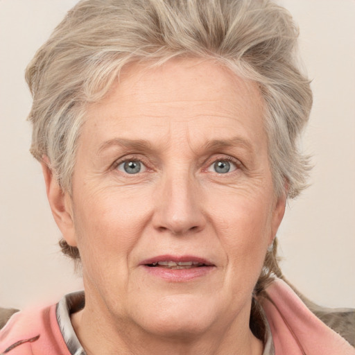 Joyful white middle-aged female with medium  blond hair and grey eyes